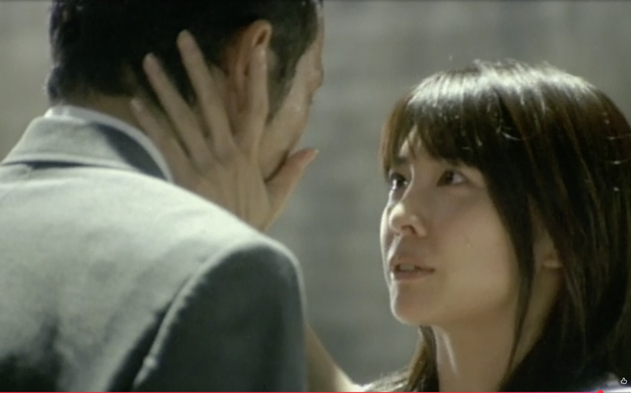 A woman holds a man’s cheeks in the movie “Be with You”.